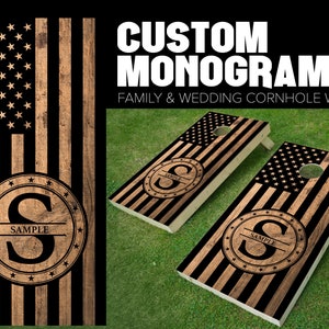May include: Two wooden cornhole boards with a black and brown American flag design. Each board features a circular monogram with a letter "S" and the word "SAMPLE" underneath.  Custom Monogram Family & Wedding Cornhole Wraps.