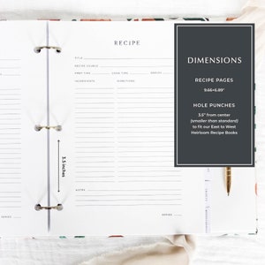 May include: A white recipe book with a black and white floral design on the cover. The book is open to a blank recipe page with lines for writing. The book is 9.66 inches by 6.89 inches and has 3.5 inch holes for a binder.