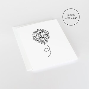 May include: A white card with a black and white illustration of a heart-shaped balloon with the text "happy birthday" inside. The balloon has a string attached to it. The card is 4.25 inches by 5.5 inches.