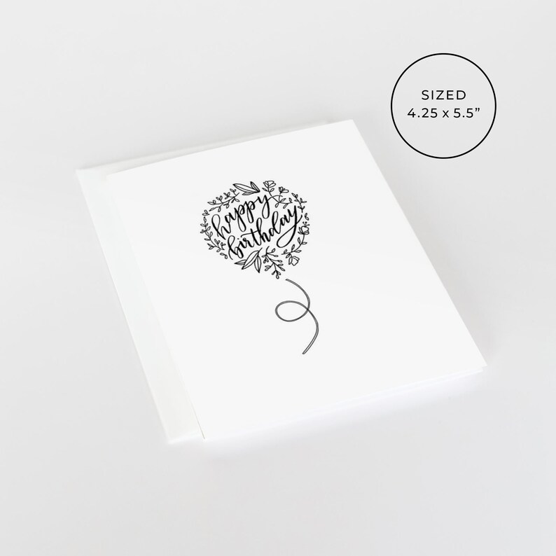 May include: A white card with a black and white illustration of a heart-shaped balloon with the text "happy birthday" inside. The balloon has a string attached to it. The card is 4.25 inches by 5.5 inches.