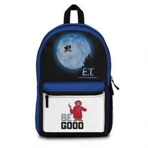 May include: Blue and black backpack with a white pocket featuring a cartoon character in a red hoodie with the text "BE GOOD". The main compartment of the backpack features a black and blue image of the moon with a silhouette of ET flying on his bicycle with the text "E.T. THE EXTRATERRESTRIAL."