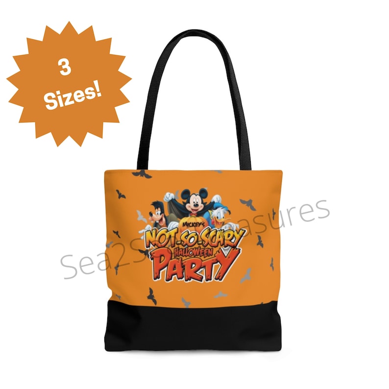 May include: Orange tote bag with black handles and a black bottom. The bag features a Mickey Mouse Halloween party design with Mickey Mouse, Donald Duck, and Goofy. The text on the bag reads "Mickey's Not-So-Scary Halloween Party".