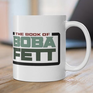 May include: White ceramic mug with a black and green graphic that says "The Book of Boba Fett".