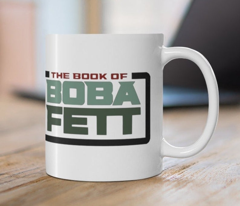May include: White ceramic mug with a black and green graphic that says "The Book of Boba Fett".