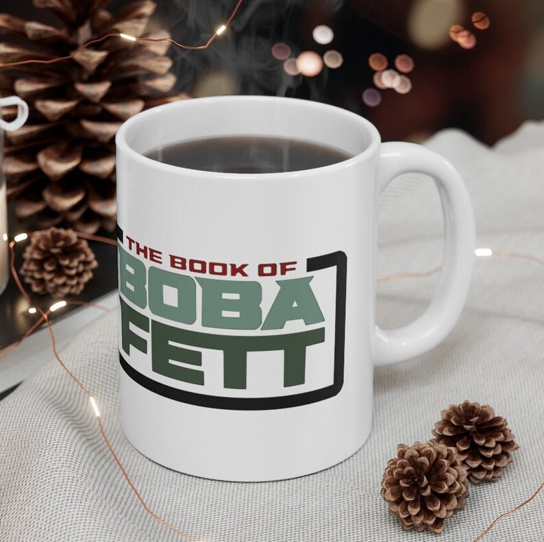 May include: White ceramic mug with a black and green graphic that says "The Book of Boba Fett".
