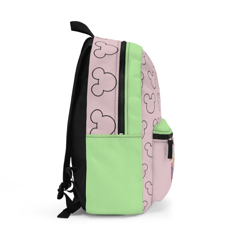 May include: A pink and green backpack with a black zipper and a pattern of black Mickey Mouse heads.