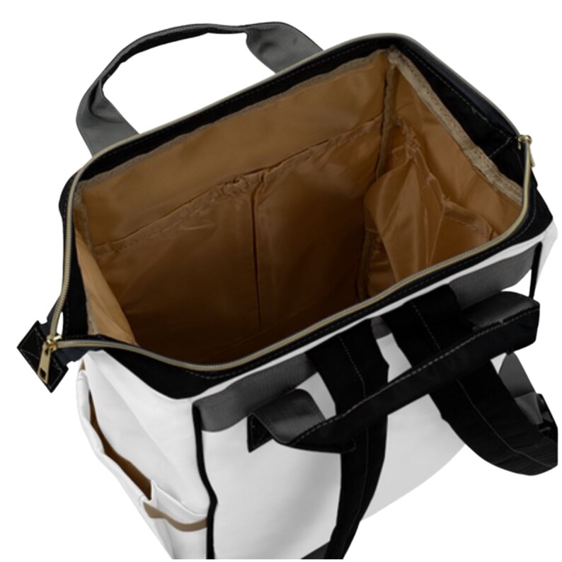 May include: A white and black backpack with a brown lining. The backpack has a zipper closure and multiple pockets.