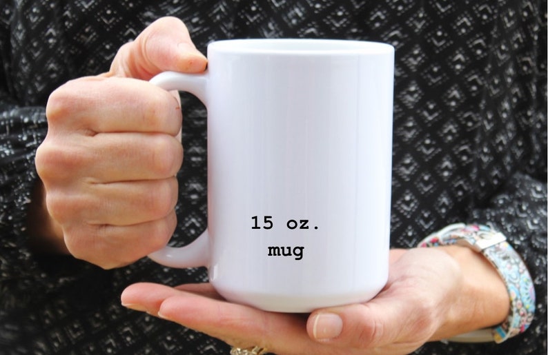 May include: White ceramic mug with a black inscription that reads "15 oz. mug".