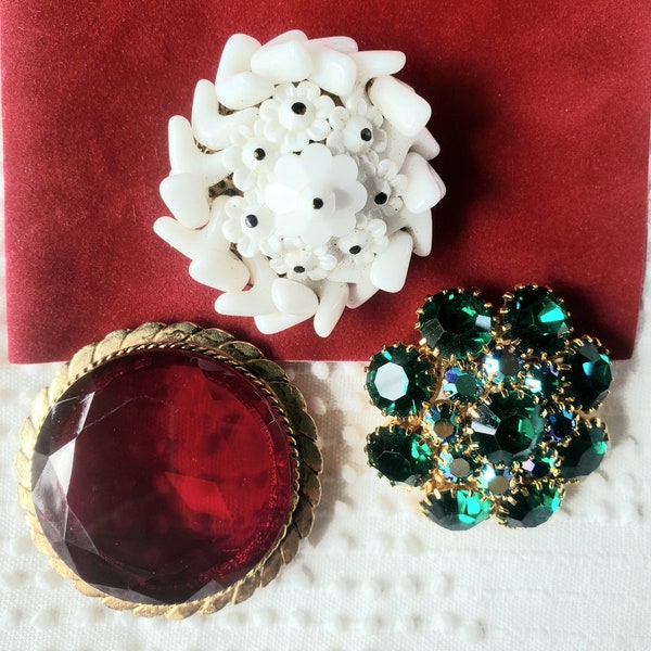 Vintage glass brooches, milk glass, green rhinestone prong set pin, red glass faceted brooch, sold separately.
