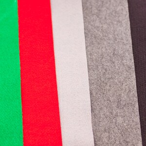 May include: Five fabric swatches in different colors: green, red, white, gray, and black. The swatches are arranged vertically, side by side.