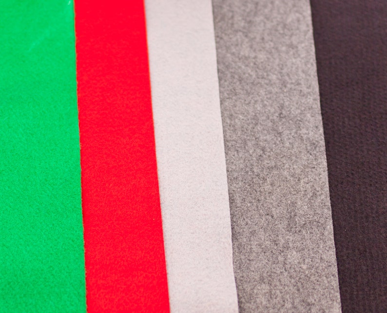 May include: Five fabric swatches in different colors: green, red, white, gray, and black. The swatches are arranged vertically, side by side.