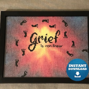 May include: Framed cross-stitch art with the words "Grief is non-linear" in black script. The background transitions from blue to orange, with black footprints circling the text. A blue "Instant Download" sticker is in the bottom right corner.