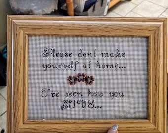 Cross stitch sassy quote saying "Please don't make yourself at home, Ive seen how you live"