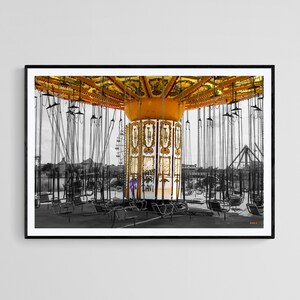 May include: A framed photograph of a carnival swing ride. The ride's canopy is a vibrant yellow with ornate detailing. The background is in black and white, with the swing seats and chains visible. Text on the ride reads "HAPPY BIRTHDAY DAVI!"
