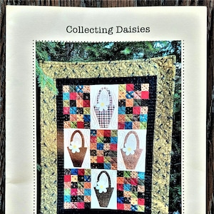 May include: A quilt pattern for a quilt titled "Collecting Daisies" by Dariene #DEON designs. The quilt measures 18 inches by 24 inches and features a patchwork design with four embroidered baskets of daisies.