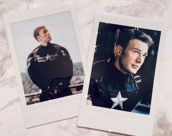 May include: Two Polaroid photos of a man dressed as Captain America. The first photo shows the man looking up with a serious expression. The second photo shows the man looking to the side with a more relaxed expression.