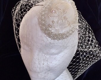 Wedding headpiece, pearl hair piece, Satin base bridal headpiece with birdcage, handmade in an ivory colour with creamy feathers and pearl.