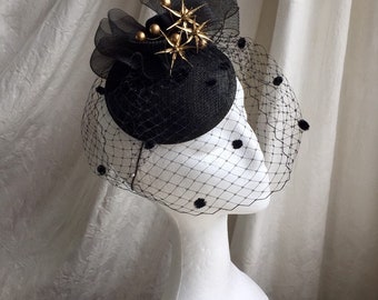 Black and gold hat , wedding, horse racing special occasion headpiece, tocado, with birdcage veil.