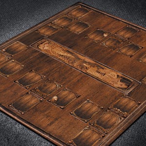 May include: A detailed, square wooden game board with a dark brown finish. The board features multiple recessed areas with decorative metal accents and a central, carved design. The overall aesthetic is vintage and handcrafted.