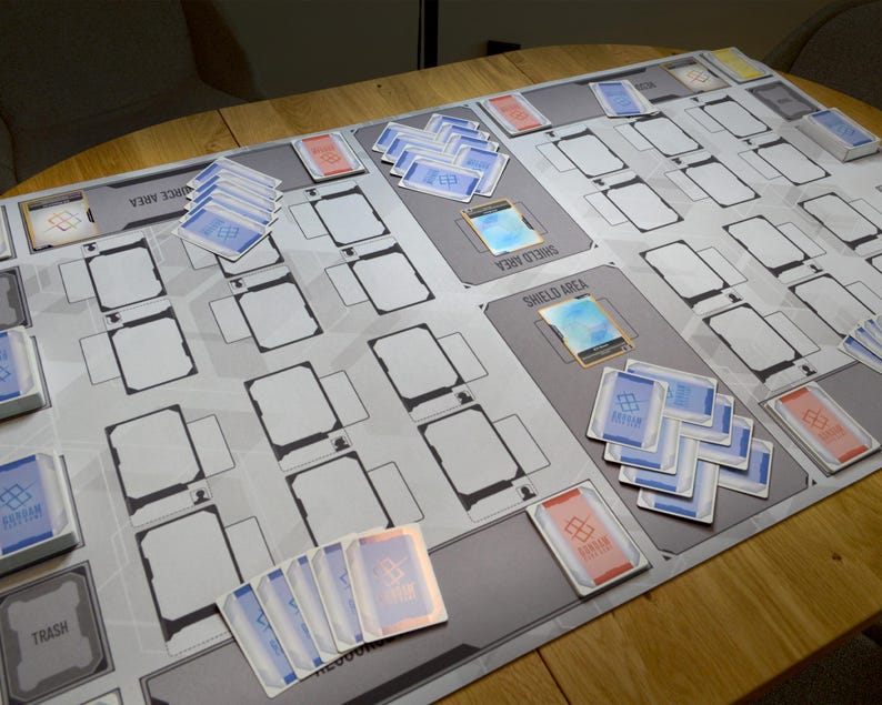 May include: A white ceramic mug with a black handle and the text "But First, Coffee" in a black, handwritten-style font. The mug is on a white surface.