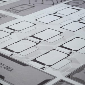 May include: A grayscale game board with various labeled areas, including "SHIELD AREA" and "RESOURCE AREA." The board features numerous rectangular spaces with rounded corners, outlined in black, and a geometric background pattern.