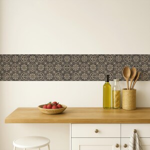 May include: A kitchen scene featuring a wooden countertop with a woven basket of strawberries, olive oil, and wooden spoons in a woven holder. A decorative border with a repeating pattern of gray and beige tiles adorns the wall.
