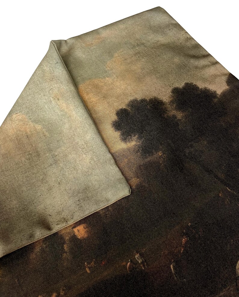 May include: A brown and beige throw pillow with a vintage landscape scene printed on the front. The scene features a group of people in a field with trees in the background.