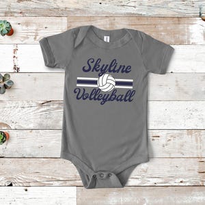 a baby bodysuit with a volleyball design on it