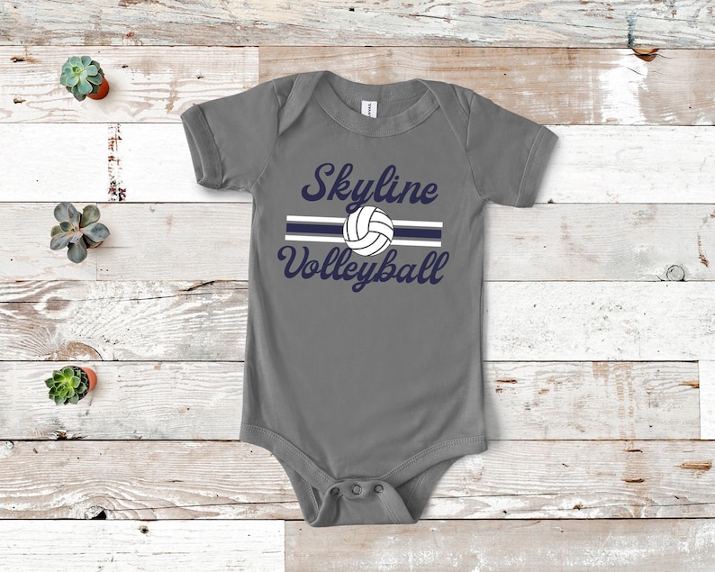 a baby bodysuit with a volleyball design on it