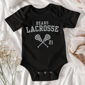 a baby bodysuit that says bears lacrosse on it