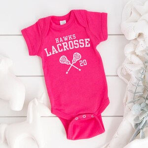 a baby bodysuit with a tennis racquet on it