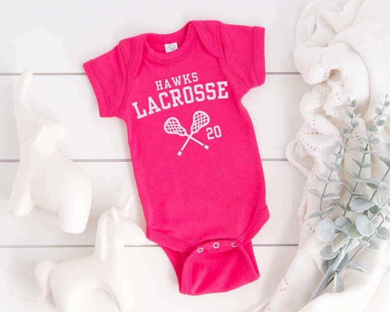 a baby bodysuit with a tennis racquet on it