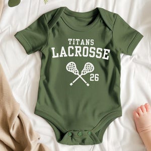 a baby bodysuit that says titans lacrosse on it