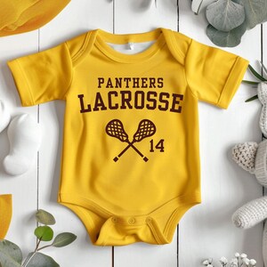 a baby bodysuit with a lacrosse design on it