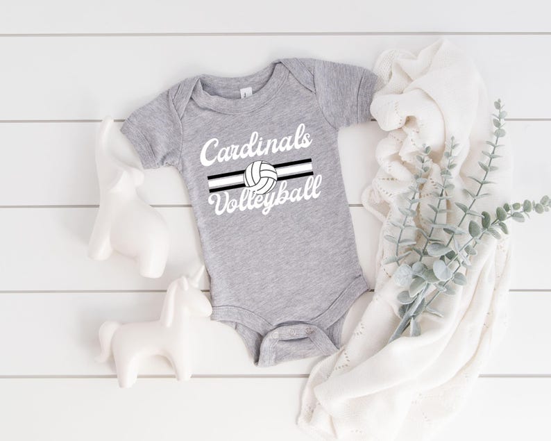 a baby bodysuit with the words cardinals volleyball on it