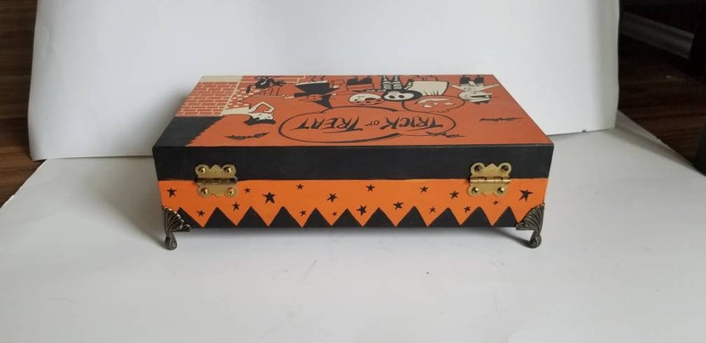All hand painted vintage Halloween candy bag art on a wooden box