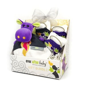 May include: A gift box filled with baby items, including a purple and green dragon plush toy, a white burp cloth with a black and green design, and a white and purple bib with a green design. The box is labeled "ever after baby" and "gift bundle".