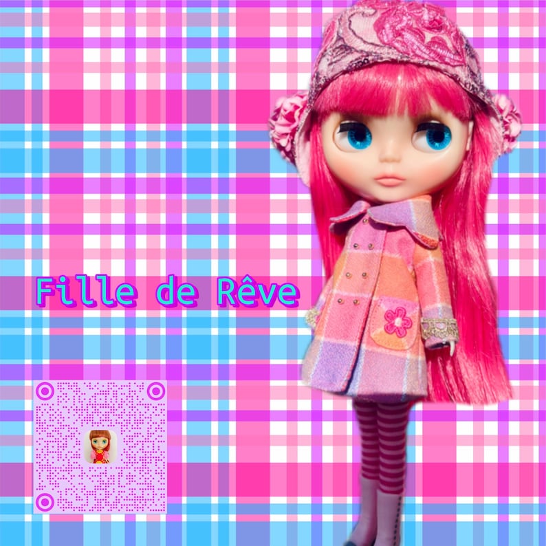 May include: A pink and white plaid doll with pink hair, wearing a pink and white plaid coat, a pink and white striped hat, and pink and white striped leggings. The doll is standing on a pink and blue plaid background. The text "Fille de R&ecirc;ve" is written in pink letters on the background.
