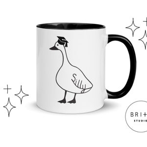 graduation era silly goose 2 tone mug black and white ceramic mug with graphic printed on both sides.