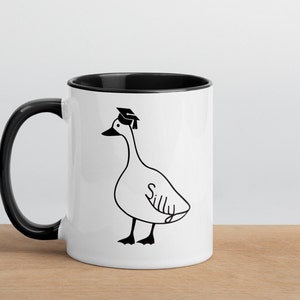 graduation era silly goose 2 tone mug black and white ceramic mug with graphic printed on both sides.