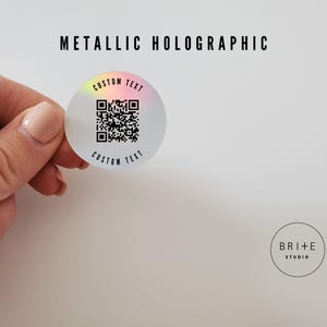 custom text 2 inch metallic holographic qr code sticker shown against white background.