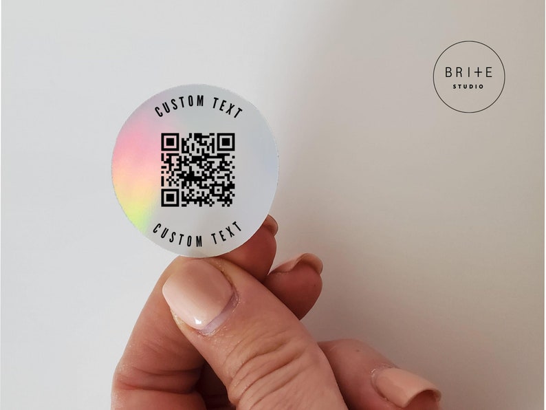 custom text 2 inch metallic holographic qr code sticker shown against white background.