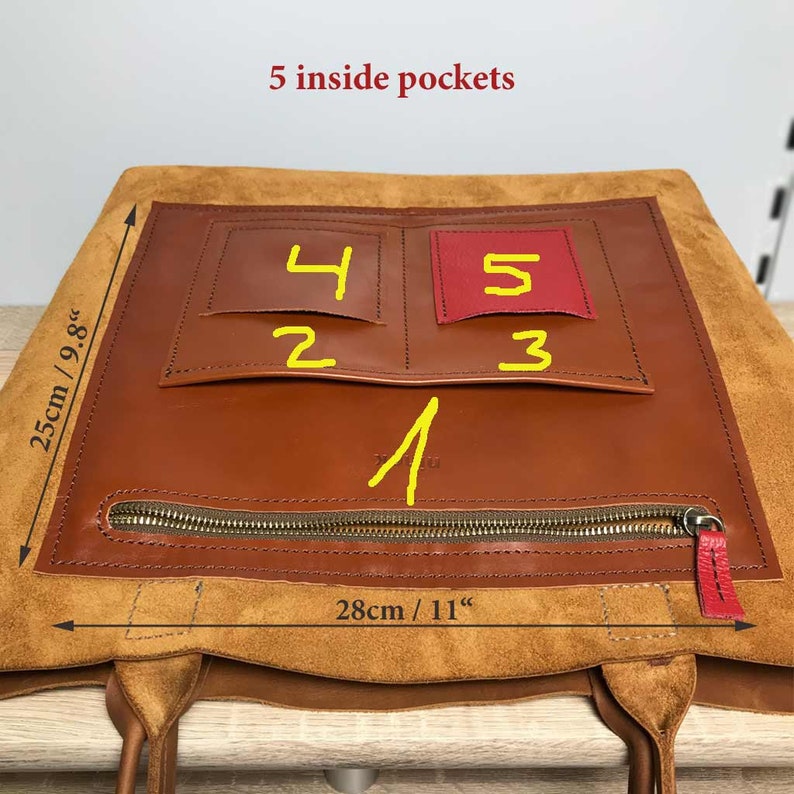 May include: A brown leather tote bag with five inside pockets. The pockets are numbered 1 through 5. The bag measures 28cm wide and 25cm tall.