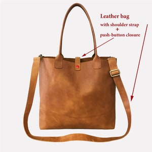 May include: A brown leather tote bag with a shoulder strap and a push-button closure.