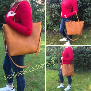 May include: A brown leather tote bag with a long strap. The bag is being worn by a person wearing a red jumper and blue jeans. The text "Handmade Leather bag" is visible in the image.