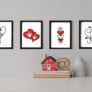 May include: Set of four framed prints featuring red hearts and the American Sign Language symbol for "I love you".