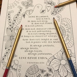 May include: A black and white coloring page featuring a floral design with a butterfly and a quote about love from 1 Corinthians 13:4-8. The quote reads: "Love is patient, love is kind. It does not envy, it does not boast, it is not proud. It does not dishonor others, it is not self-seeking, it is not easily angered, it keeps no record of wrongs. Love does not delight in evil but rejoices with the truth. It always protects, always trusts, always hopes, always perseveres. Love never fails. 1 Corinthians 13:4-8"