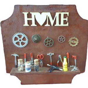 May include: A wooden sign with the word "HOME" in white letters and a heart in the middle. The sign has a shelf with miniature tools, jars, and a bottle of oil. There are also gears on the wall behind the shelf.