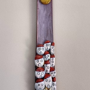 Painting with houses of colored sea stones, plus surprise tribute