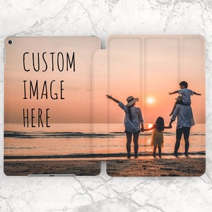 May include: A family of four silhouetted against a sunset on a beach. The parents are holding hands with their two children. The father is carrying the younger child on his shoulders. The image is a warm and inviting depiction of family togetherness.
